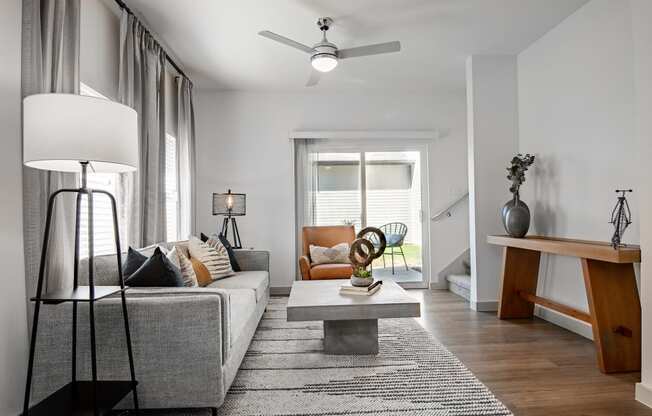 a living room with a gray couch and a coffee table