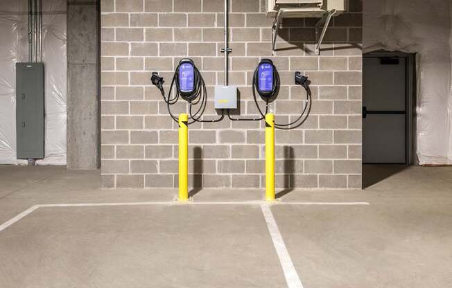 a parking meter in front of a brick wall