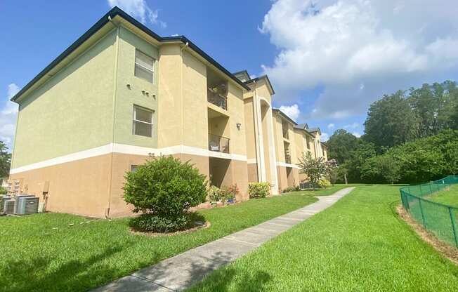 Apartment building exterior surrounded by native landscaping