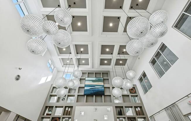 a view of the lobby of a building with spheres hanging from the ceiling