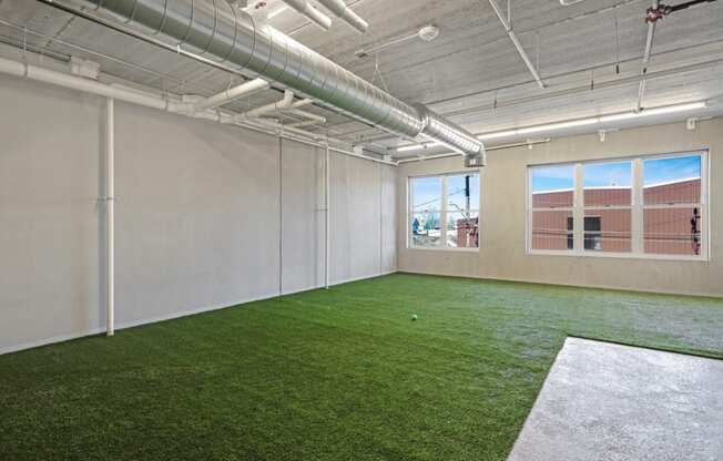 the interior of an office with green turf on the floor