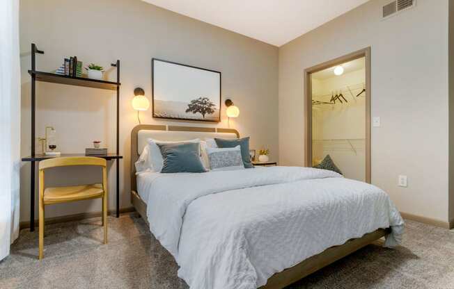 a bedroom with a large bed and a mirror