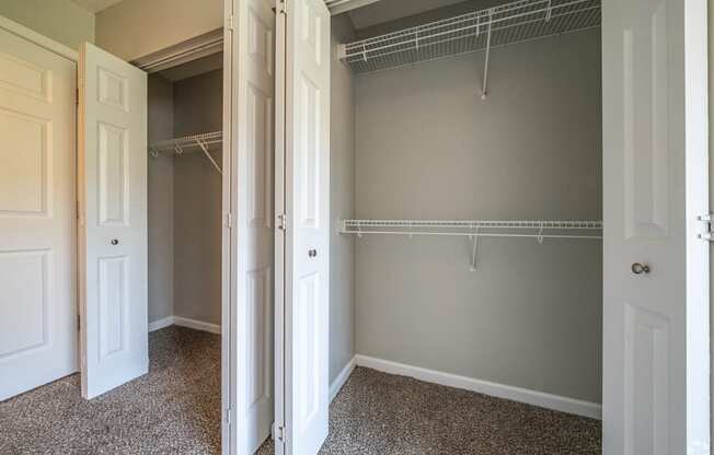 an empty closet in an empty room with closet doors