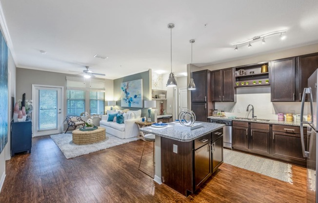 a kitchen and living room with wood flooring and