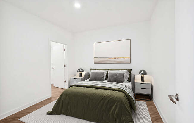 Model Bedroom with Wood-Style Flooring and attached Bathroom at Stella Apartments located in New Carrollton, MD.