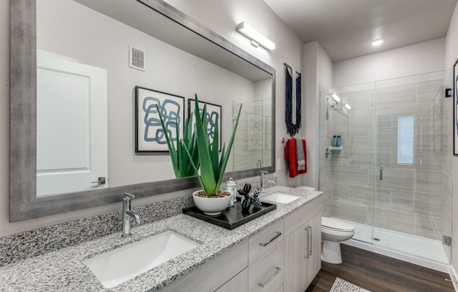 A bathroom with a white sink and a white toilet.