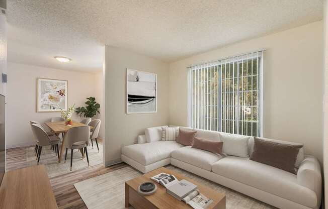 A living room with a white couch and a coffee table.