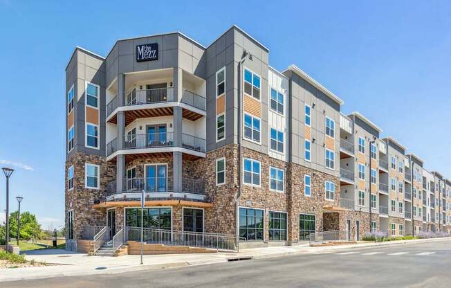 a large apartment building with a street in front of it