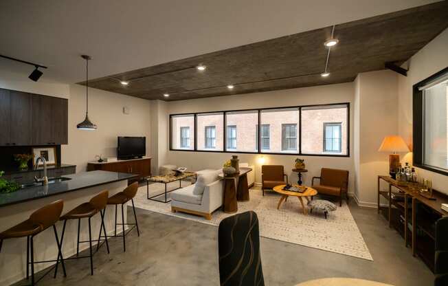 a living room with a kitchen and a large window  at The Lady, Columbia, SC, 29201