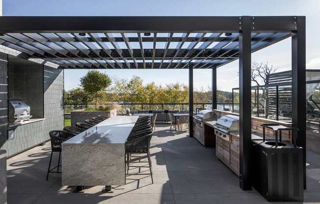 A patio with a table and chairs under a roof.