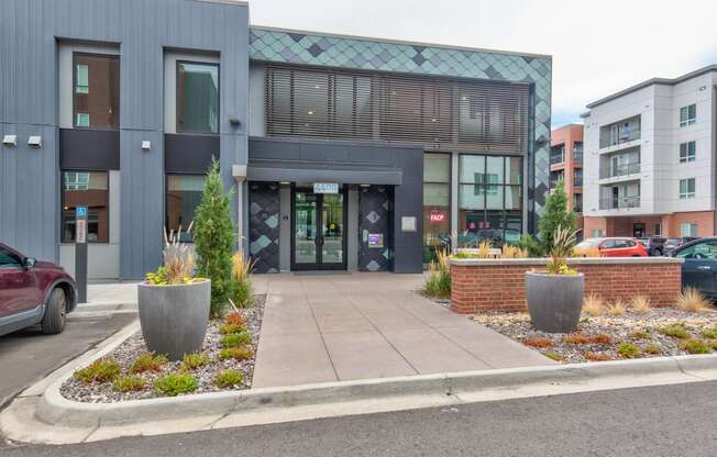 the front of a building with a sidewalk and planters