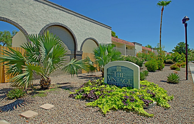 the entrance to the village entrance sign in front of a building