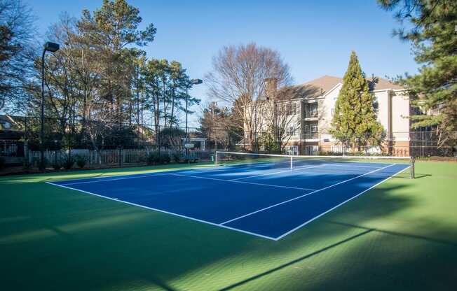 a tennis court with a house in the background at Willowest in Lindbergh, Atlanta, Georgia