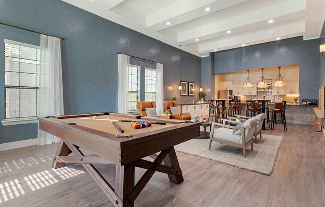 a pool table in a living room with a bar and a dining room at Summerwind, Pearland, 77584
