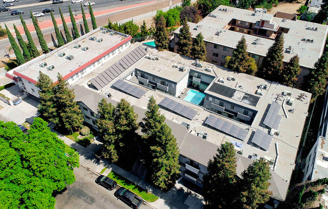 Aerial drone image of building with view of solar panels.