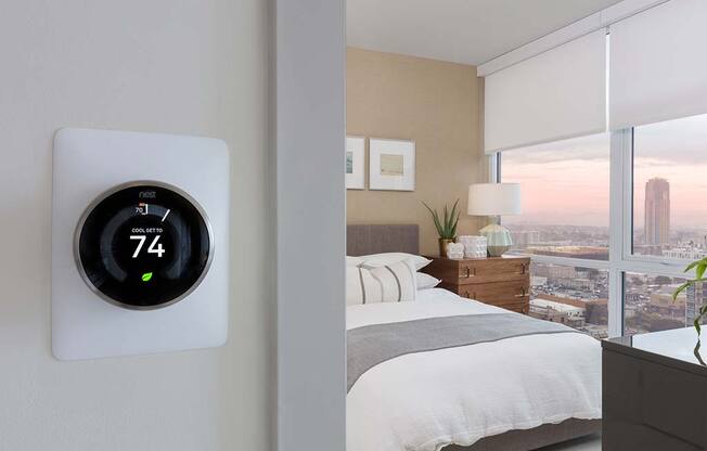 Thermostat with bedroom view at The Rey Apartments in California