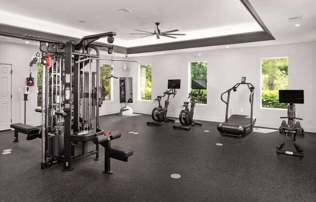 a gym with weights and cardio equipment in a luxury home