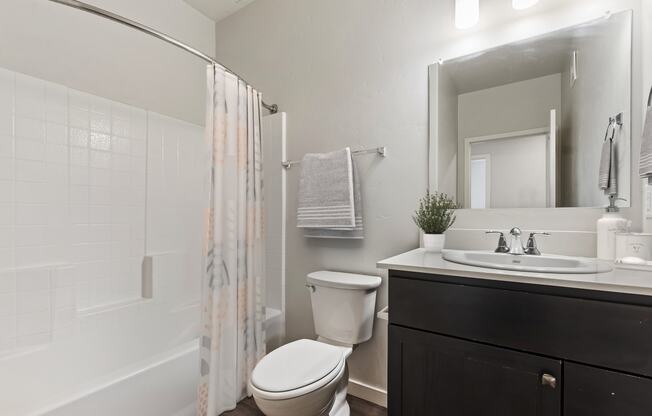 a bathroom with a toilet sink and shower