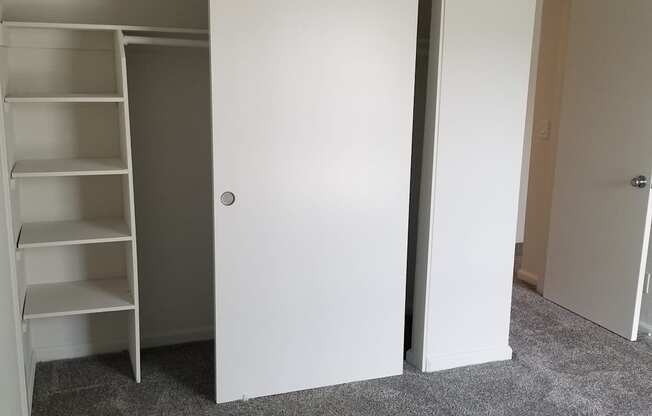 2x1 Secondary bedroom closet with grey carpet