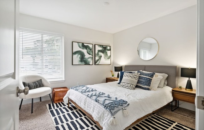 a bedroom with a bed and a chair in a 555 waverly unit at Linkhorn Bay Apartments, Virginia Beach