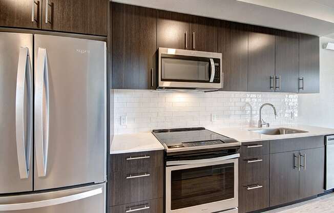 Downtown Seattle WA Apartments-Metroline Flats Apartments Kitchen With Wooden Cabinetry And White Tile Backsplash