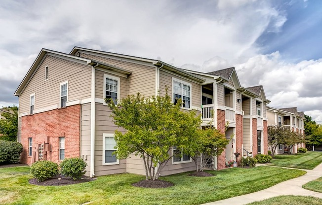 Park at Eagle Creek building exterior. tan siding with red brick