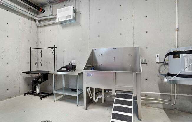 A room with a stainless steel table and a white cabinet.
