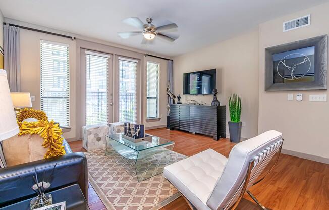 a living room filled with furniture and a large window