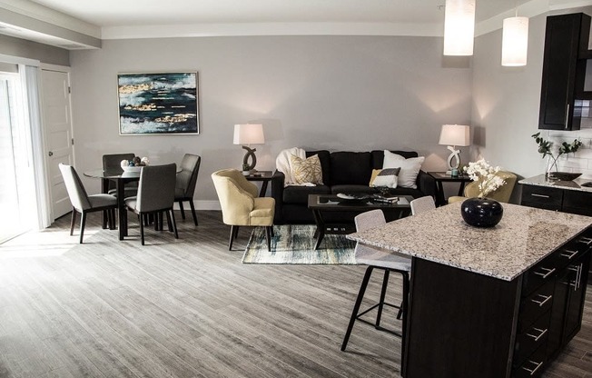 A modern living room with a grey carpet and a black and white sofa.