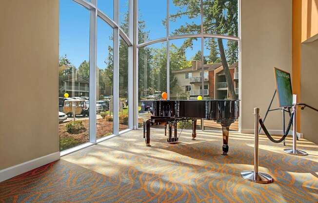 A hallway with a carpeted floor and a glass wall.