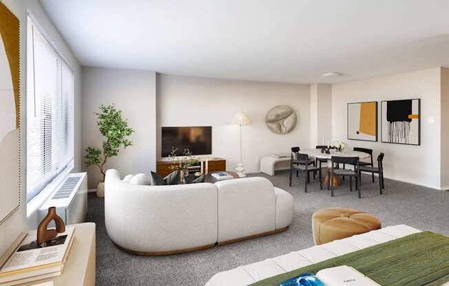 A living room with a white couch, a green rug, and a painting on the wall.