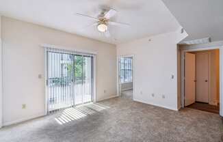 an empty living room with a ceiling fan and a window at St. Augustine Estate, Dallas