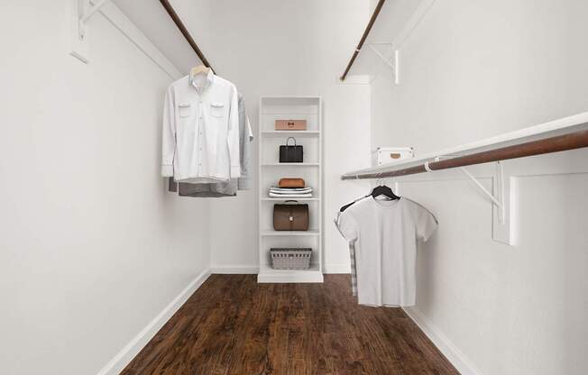 A white shirt hanging on a rail in a room with wooden floors.