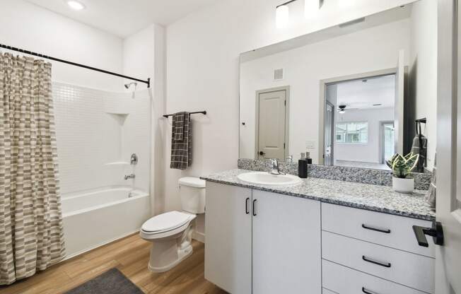 a bathroom with a shower toilet and sink and a mirror at Gibson Oaks, Lakeland, 33809