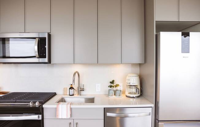 Studio unit with a kitchen with stainless steel appliances and cabinets at Book Tower, Michigan, 48226