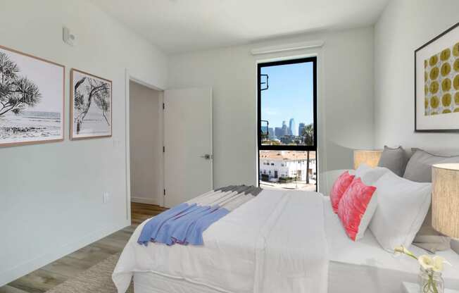 a bedroom with a large bed and a door that leads to a balcony