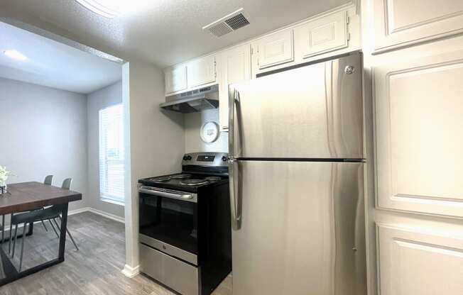 a kitchen and dining area in a 555 waverly unit  at 2151 Kirkwood, Houston