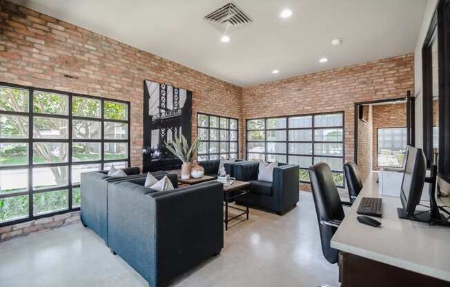 a living room with a brick wall and a large window