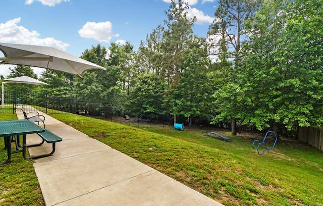 a picnic area with a picnic table and benches in a park