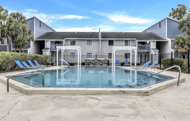 a swimming pool with a house in the background