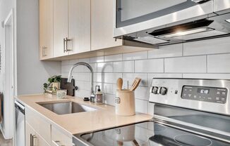 a kitchen with a sink and a stove