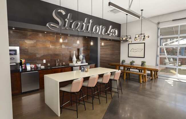a dining room with a long table and chairs in front of a wall with a