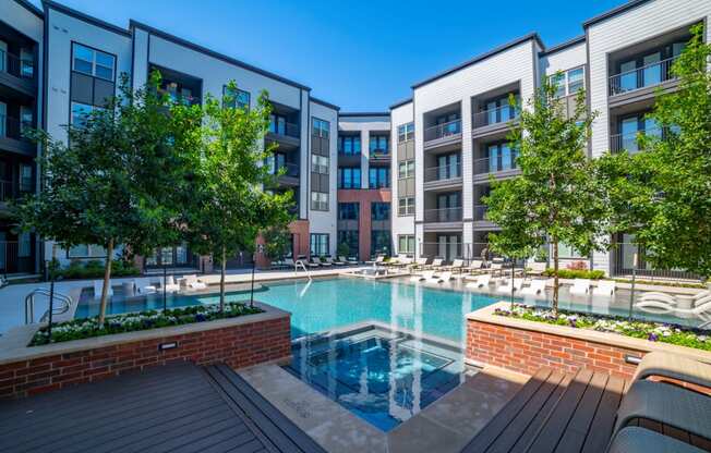 a swimming pool in front of some apartment buildings