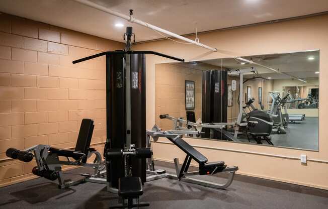 a gym with weights and mirrors on the wall. Roseville, MN Rosedale Estates Apartments