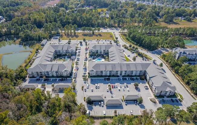 an aerial view of a resort with buildings and a pool