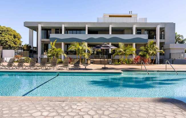 A modern house with a pool in front.