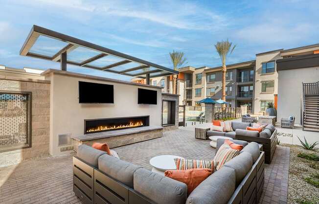 A patio with a fireplace and seating area.