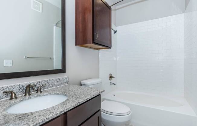 a bathroom with a sink toilet and a mirror