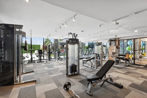 Fitness center with weights, cardio machines and cable weight machines at Bay Village 1 in Palmetto Bay, FL