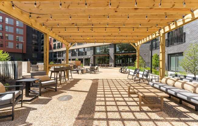 a large wooden pergola with chairs and tables on a patio at Hydro, Richmond, Virginia